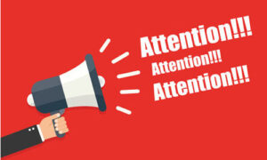 Mégaphone dans un carton rouge :Attention! Attention! Attention!